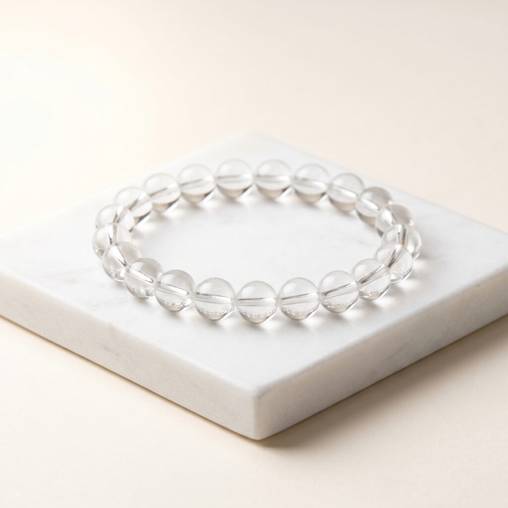 Clear Quartz Bracelet on a white marble stone Top 5 Crystals to Attract Money and Abundance