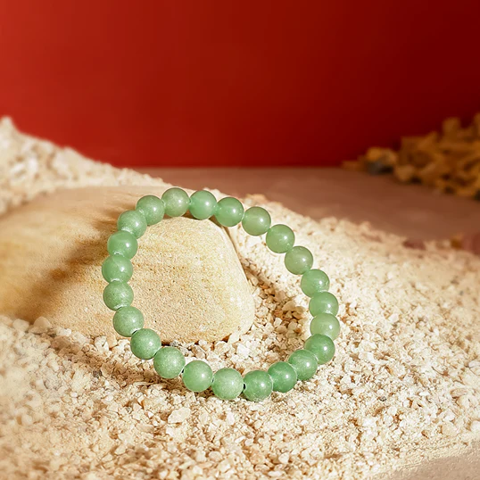 Green Aventurine bracelet on a stone background
