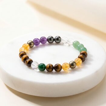 Money Magnet Bracelet featuring Green Aventurine, Jade, Citrine, Tiger's Eye, Clear Quartz, Golden Pyrite and Amethyst crystals placed on a marble plate
