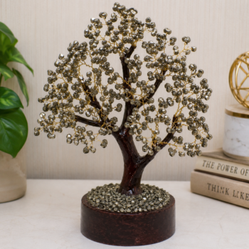 Handcrafted Pyrite Crystal Tree with natural pyrite crystal chips, resin trunk, books and green plants in a luxury home décor setting
