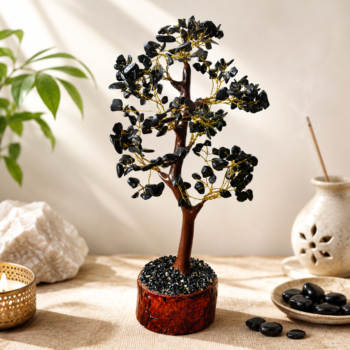 Black Tourmaline crystal tree with gold wire branches on a warm neutral background