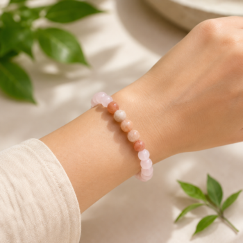 Kark Rashi (Cancer) natural crystal bracelet featuring Rose Quartz, Moonstone and Sunstone beads worn on a woman's wrist.