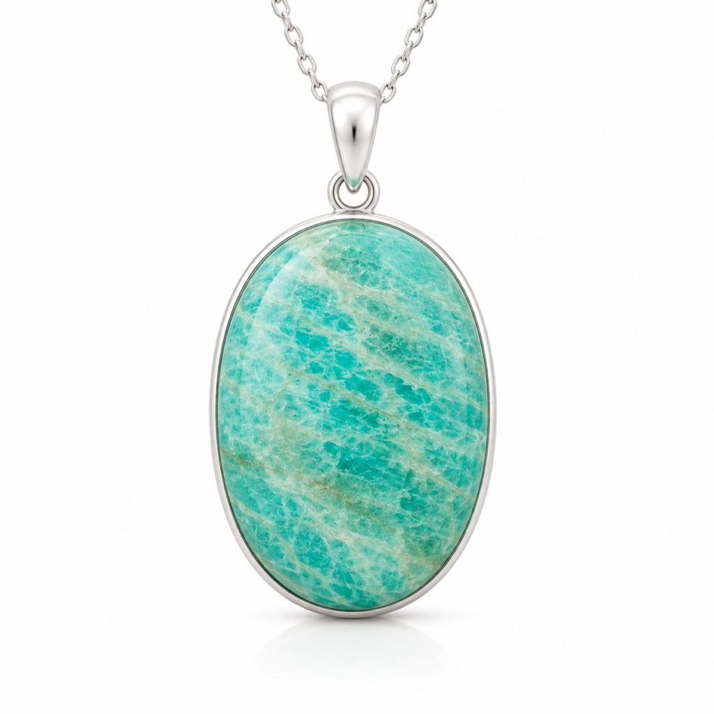 Natural Amazonite pendant with a polished oval cabochon in a sterling silver bezel on a white background. Traditionally associated with honest communication, emotional balance, healthy boundaries, and the Throat Chakra.