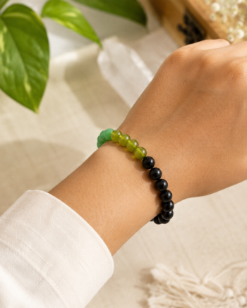 Person wearing a Kanya (Virgo) Rashi bracelet made with natural Peridot, Green Jade and Green Aventurine gemstone beads on the wrist.