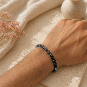 Makar Rashi Capricorn bracelet with Snowflake Obsidian, Black Onyx and Hematite beads worn on a wrist