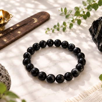 Black Obsidian crystal bracelet with polished black beads in a natural setting
