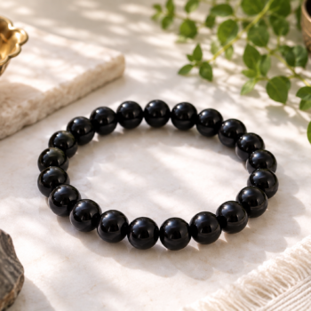 Black Onyx crystal bracelet with polished black beads in a natural setting